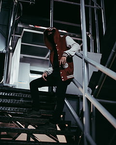 person wearing red and gray letterman jacket thumbnail