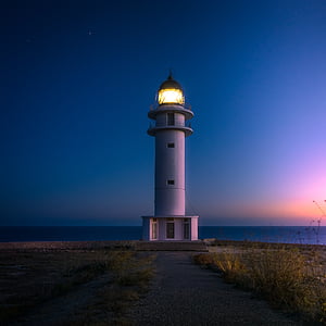 lighted lighthouse during nighttime thumbnail