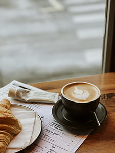 selective focus photography of coffee cup and croissant bread on platter with tissue thumbnail