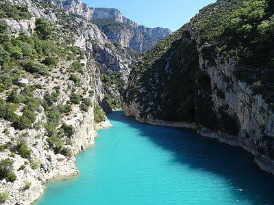 landscape photography of lake between mountains thumbnail