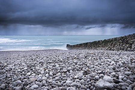 gray stone near sea shore thumbnail