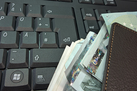 Black Keyboard with wallet and lots of money thumbnail