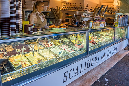 woman standing near clear display counter thumbnail