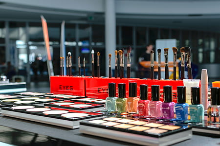 shallow focus photography of assorted makeup palettes and bottles thumbnail