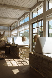 two brown pendant lamps beside loungers thumbnail