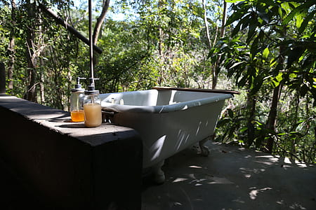 white bathtub near trees thumbnail
