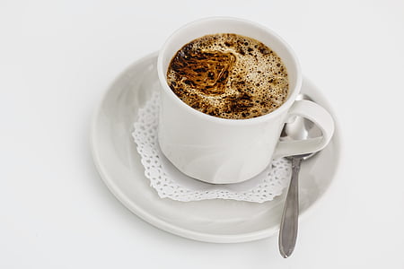 white ceramic coffee cup and saucer on white surface thumbnail