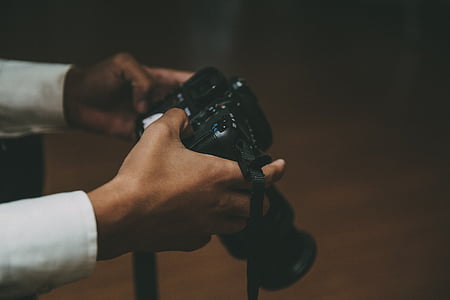 person holding DSLR camera thumbnail