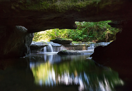 body of water under rock formation thumbnail