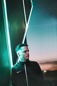 man in black Nike zip-up jacket beside LED lamp thumbnail
