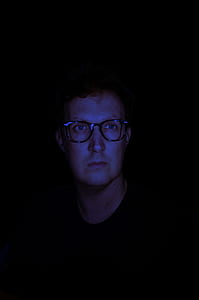 man in black crew-neck shirt with eyeglasses thumbnail