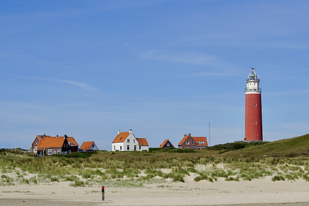 brown lighthouse near house thumbnail
