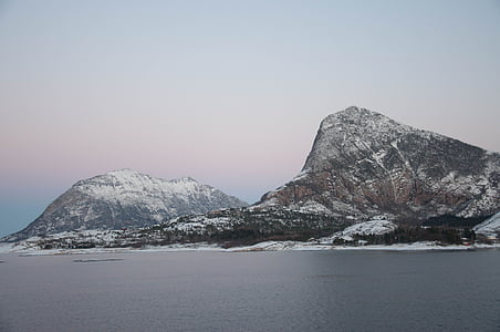gray and black mountains near body of water thumbnail