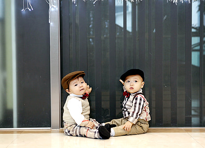 baby wearing white-and-brown-and-black plaid suit thumbnail