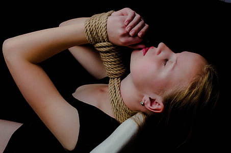woman in black bodycon dress tied with rope thumbnail