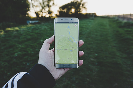 person holding phone white looking for google maps thumbnail