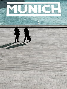 silhouette photo of a person walking on street thumbnail