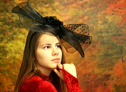 shallow focus photography of woman in red long-sleeved top wearing black ribbon thumbnail