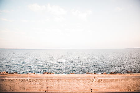 body of water under cloudy sky thumbnail