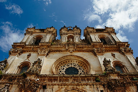 worm's eye view photography of cathedral under blue sky during daytime thumbnail