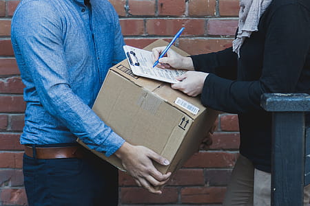 Man Signing For Shipping Box Photo thumbnail