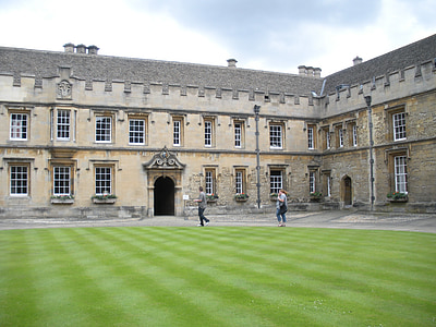two people walking beside brown building during daytime thumbnail