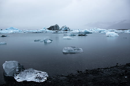 grayscale photography of calm water with ice break thumbnail