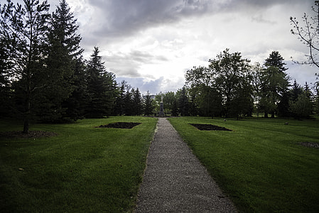 Path in the city park under dark skies in Saskatoon thumbnail