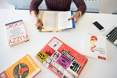 hands, books, desk, laptop thumbnail