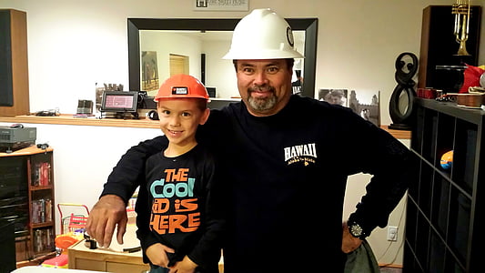 man and boy standing inside room thumbnail