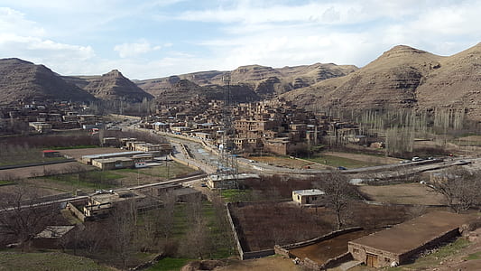 buildings within mountain range during daytime thumbnail