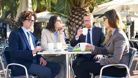 four persons having coffee outdoors thumbnail