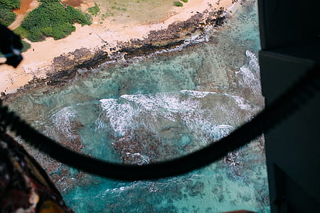 aerial photography of forest and rock formation near body of water thumbnail