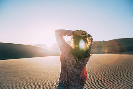 woman in dessert wearing brown cardigan holding her head thumbnail