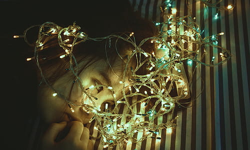 Woman Near Assorted-color String Lights thumbnail
