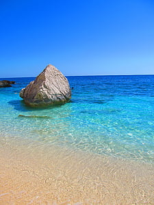 brown stone on body of water thumbnail