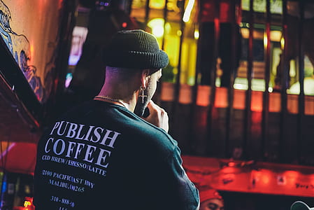 man holding microphone wearing black knit cap thumbnail