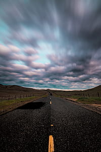 gray concrete road under blue sky thumbnail