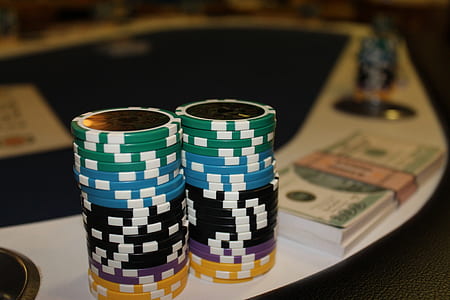 two piles of poker chips on poker table thumbnail