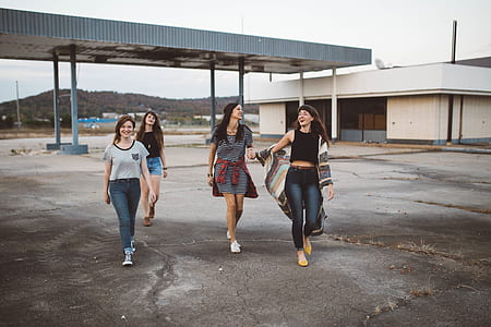 four woman walking down the street thumbnail