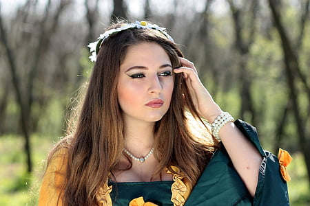 woman wearing green and yellow top near green trees thumbnail
