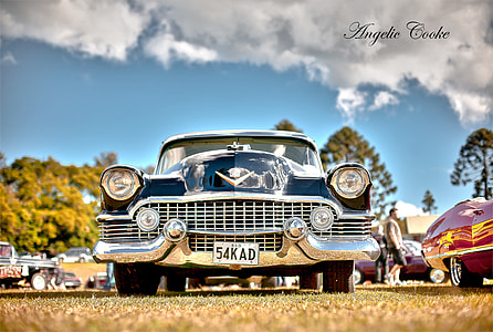 blue classic car on top of brown grass field beside cars on daytime thumbnail