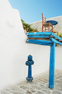 blue fire hydrant in front of wall thumbnail