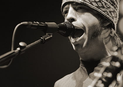 grayscale photo of man singing thumbnail