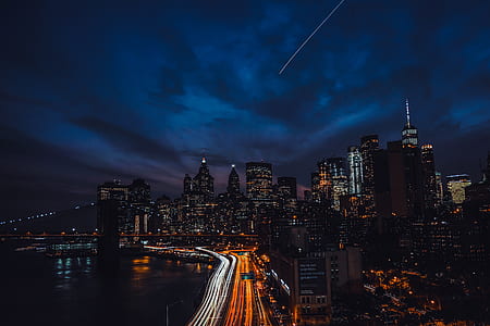 time lapse photography of road in middle of city during nighttime thumbnail