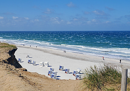 people on white sand seashore beside beach during daytime thumbnail