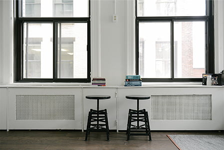 landscape photography of black bar stools near window panels thumbnail