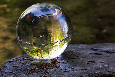 clear glass ball on rock formation thumbnail
