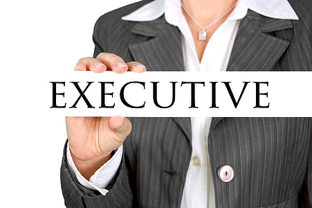 person in black button-up top holding executive signage thumbnail