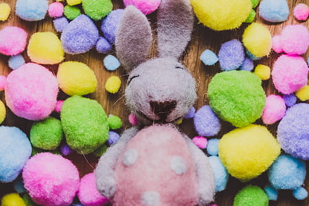 gray and pink cotton bunny beside multicolored fabric balls thumbnail